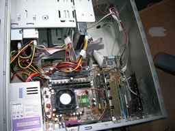 Wide view shows CPU is central with power supply above, various drives in front, various cards below and case fan behind.