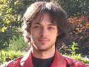 Ben Millard has black hair with blue eyes and a broad smile. He is 6 feet tall.